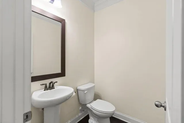 a bathroom with a sink a toilet and mirror