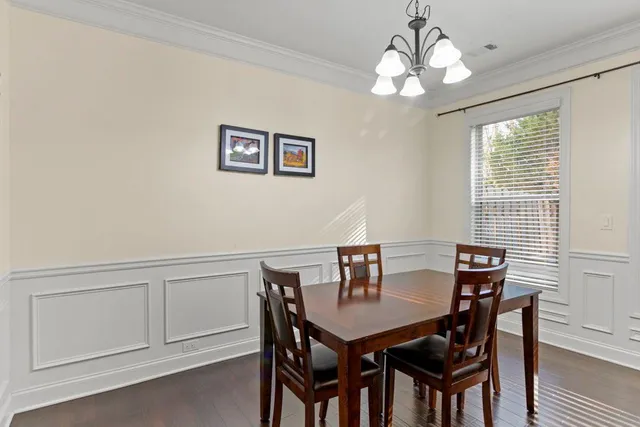 a view of a dining room with furniture and chandelier