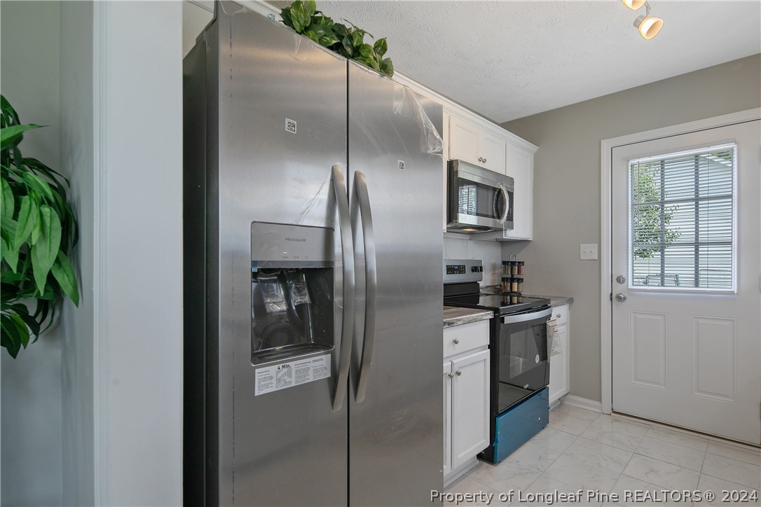 130 Rye Lane Raeford, NC 28376 - Photo 14 of 38 a kitchen with stainless steel appliances granite countertop a refrigerator and a stove