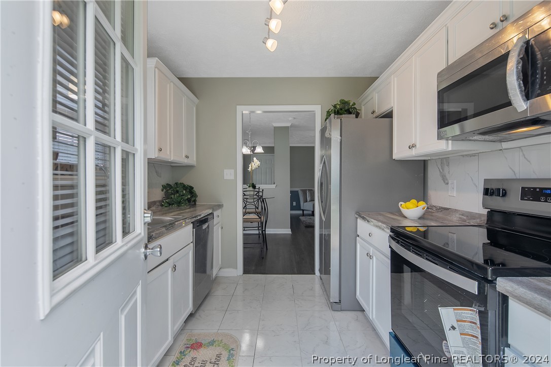 130 Rye Lane Raeford, NC 28376 - Photo 15 of 38 a kitchen with stainless steel appliances a stove refrigerator and microwave