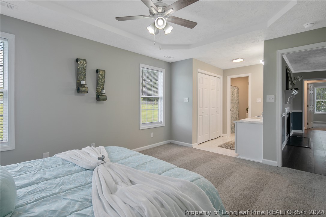 130 Rye Lane Raeford, NC 28376 - Photo 17 of 38 a bedroom with a bed and a chandelier