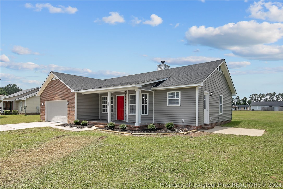 130 Rye Lane Raeford, NC 28376 - Photo 2 of 38 a front view of house with yard and trees in the background
