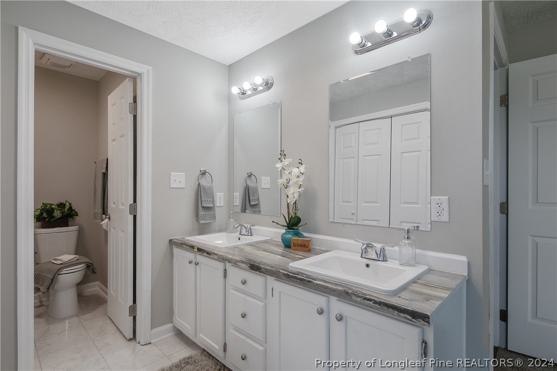 130 Rye Lane Raeford, NC 28376 - Photo 22 of 38 a bathroom with a sink and a mirror