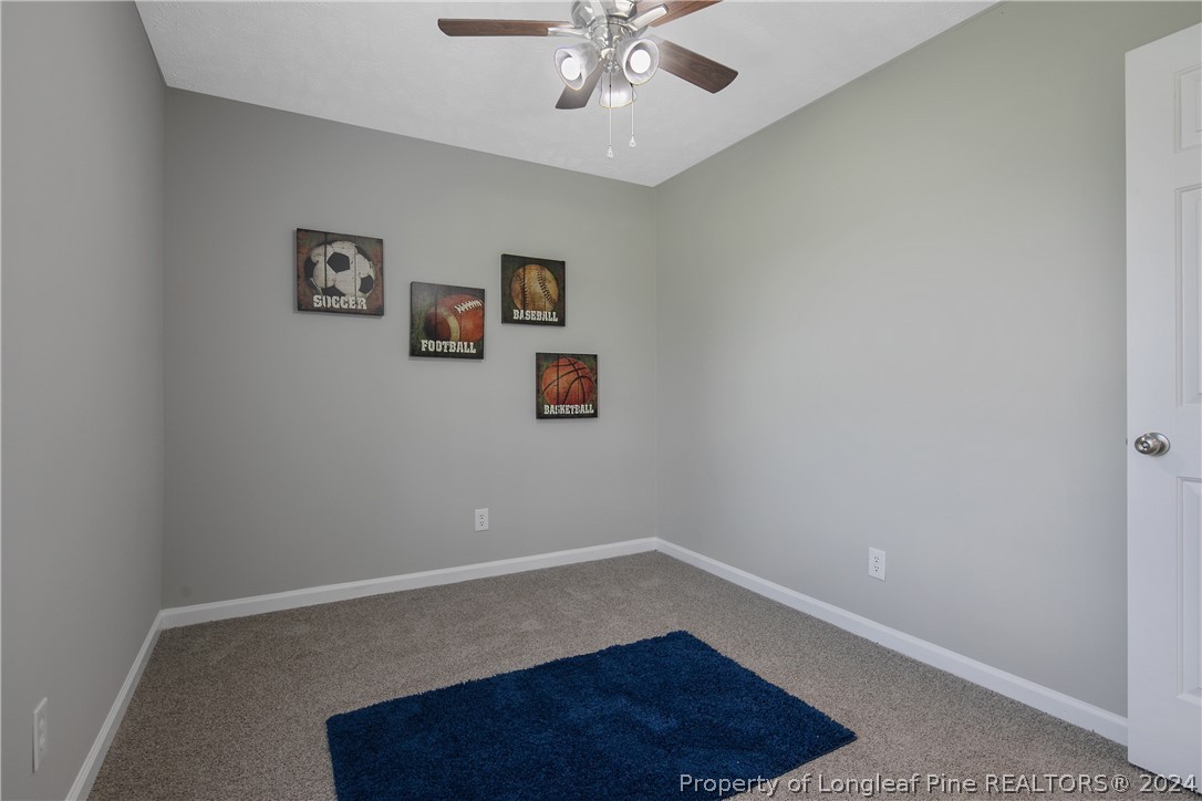 130 Rye Lane Raeford, NC 28376 - Photo 32 of 38 an empty room with a potted plant and wooden floor