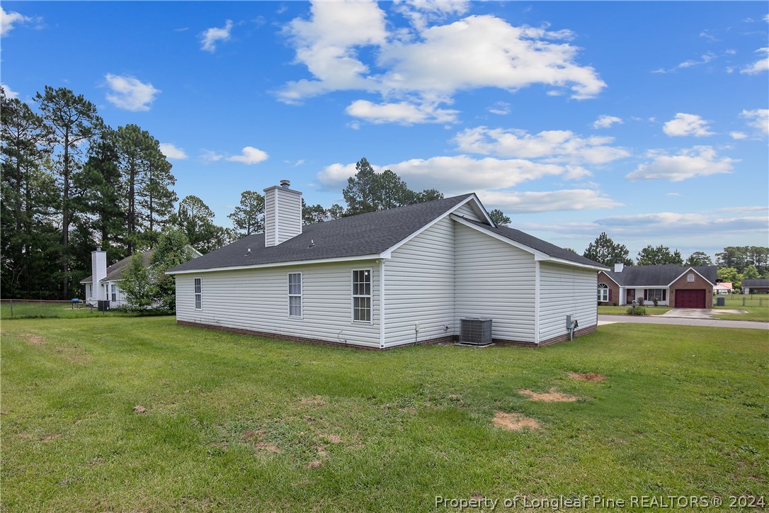 130 Rye Lane Raeford, NC 28376 - Photo 36 of 38 a view of a house with yard and a garden