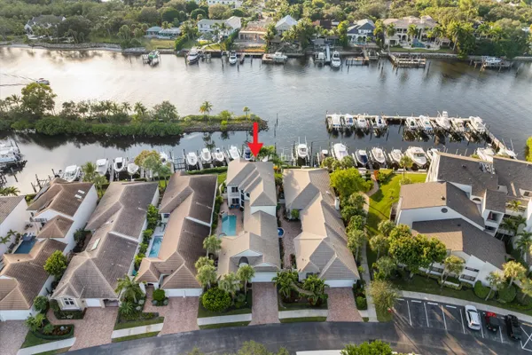 an aerial view of a house with outdoor space and lake view