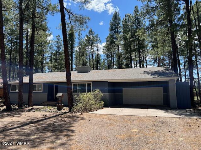 625 East Nora Place Pinetop, AZ 85935 - Photo 15 of 35 a front view of a house with a yard and garage