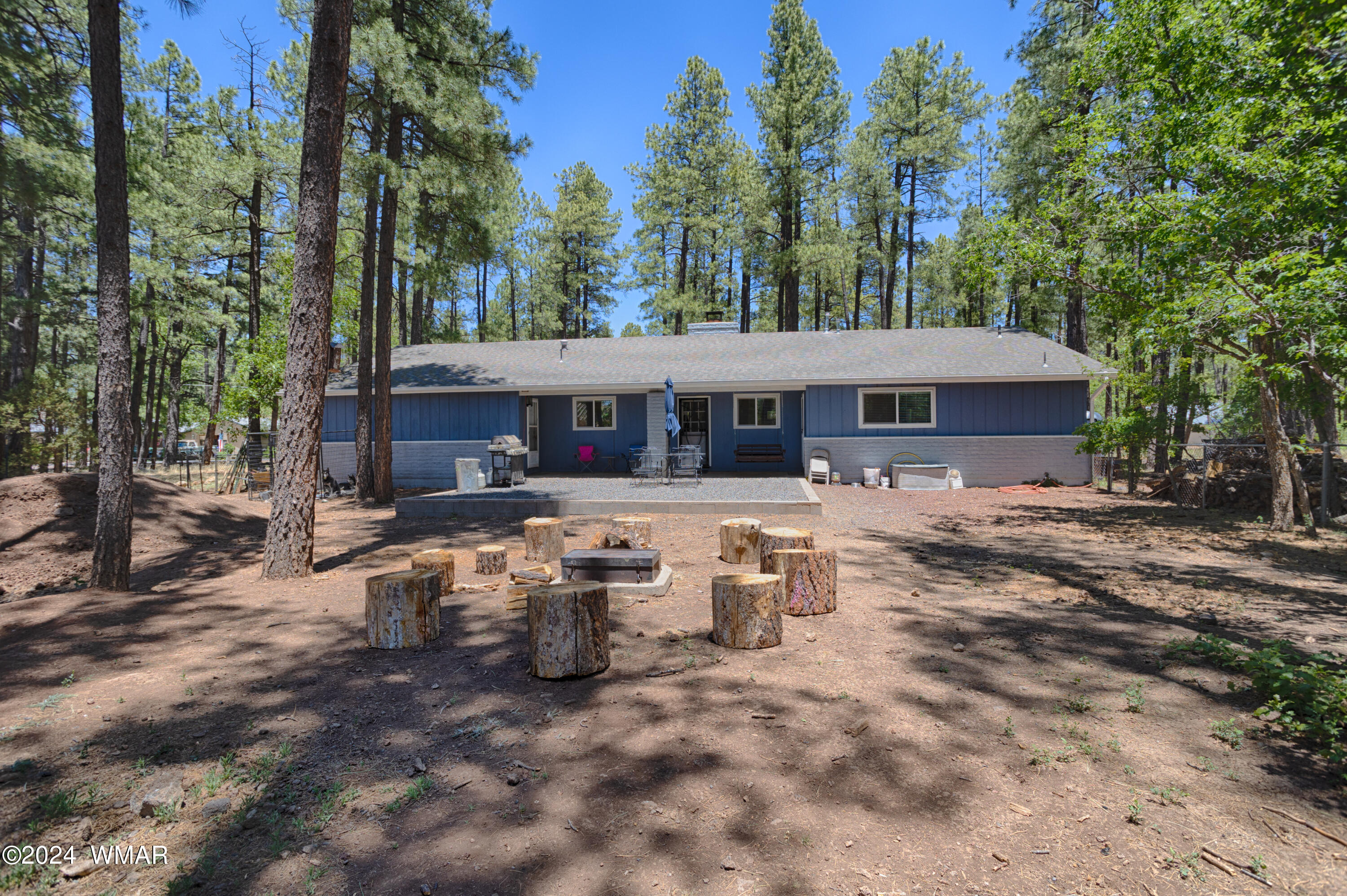 625 East Nora Place Pinetop, AZ 85935 - Photo 16 of 35 a view of a house with backyard sitting area and covered with trees