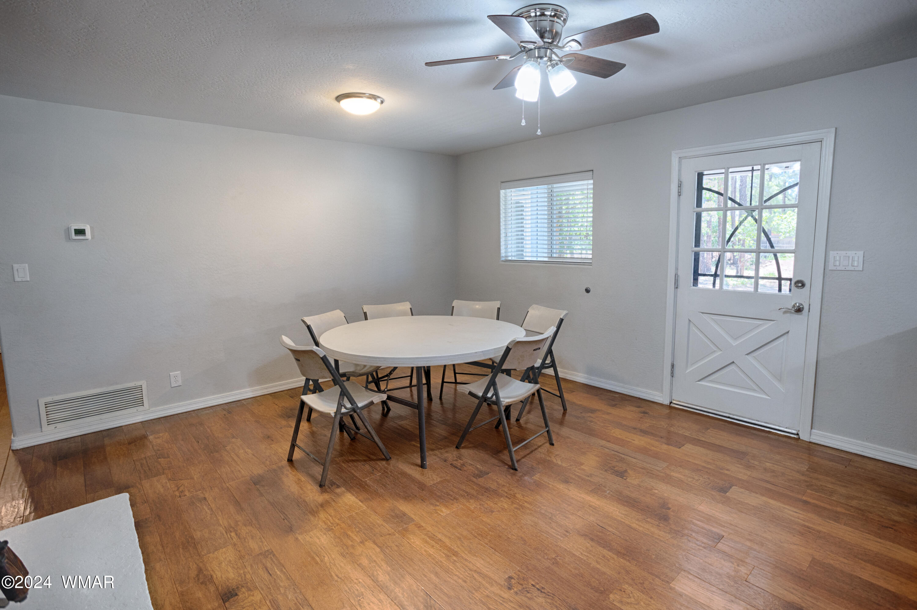 625 East Nora Place Pinetop, AZ 85935 - Photo 22 of 35 a view of a dining room with furniture and wooden floor