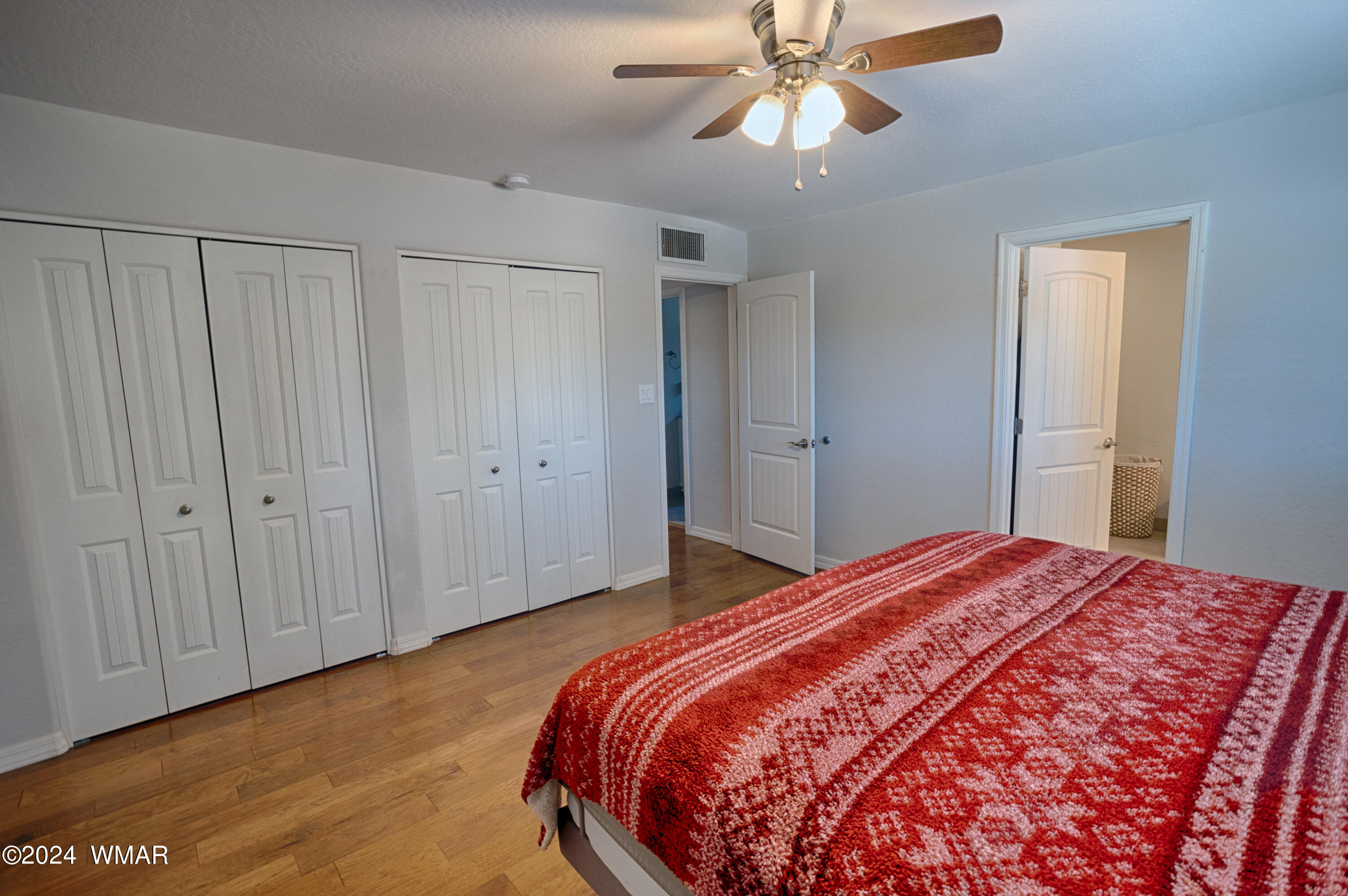 625 East Nora Place Pinetop, AZ 85935 - Photo 24 of 35 a bedroom with a bed and a chandelier fan