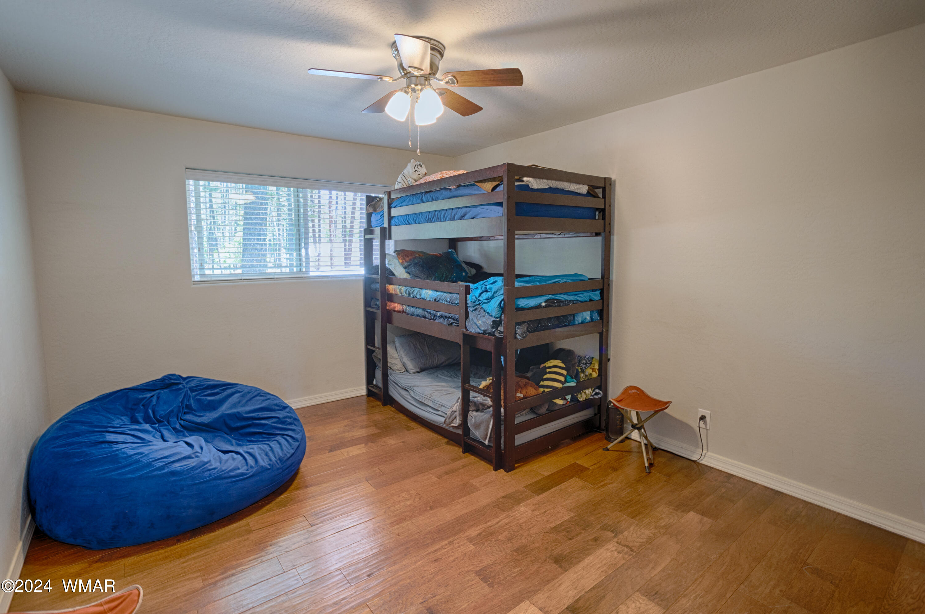 625 East Nora Place Pinetop, AZ 85935 - Photo 26 of 35 a bedroom with a bed and a chandelier