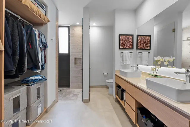 a bathroom with double vanity sink and a mirror
