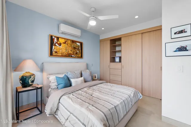 a bedroom with a bed and cabinets