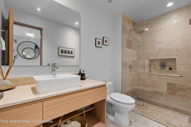 a bathroom with a sink a toilet and shower