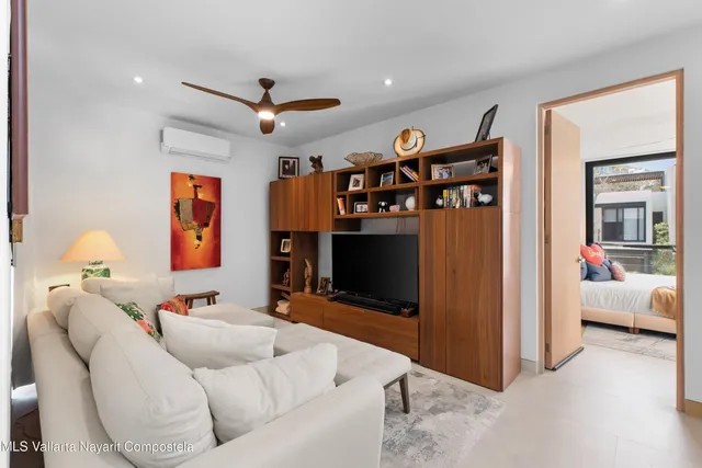 a living room with furniture and a flat screen tv