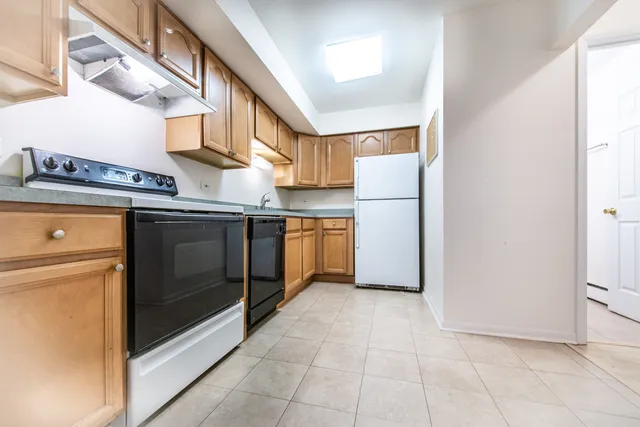a kitchen with a stove top oven and cabinets