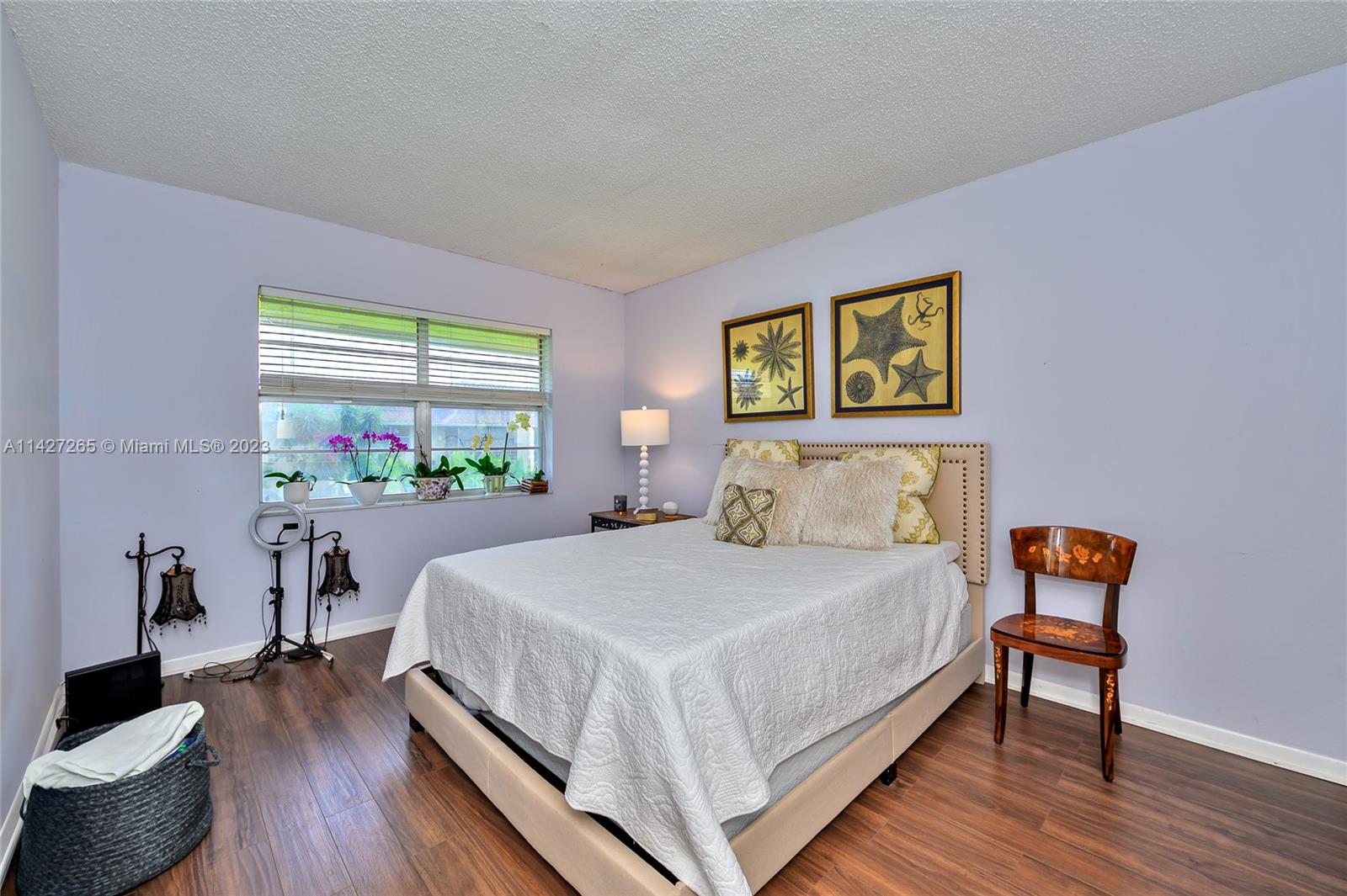 1231 Northwest 13th Street, Unit 472F Boca Raton, FL 33486 - Photo 11 of 22 a bedroom with a bed and a wooden floor
