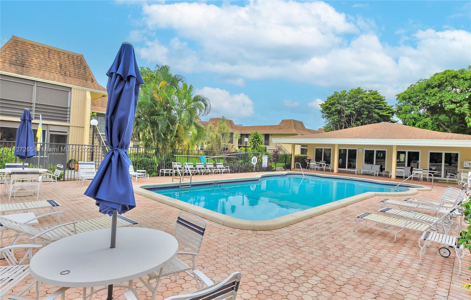 1231 Northwest 13th Street, Unit 472F Boca Raton, FL 33486 - Photo 19 of 22 a swimming pool with outdoor seating yard and barbeque oven