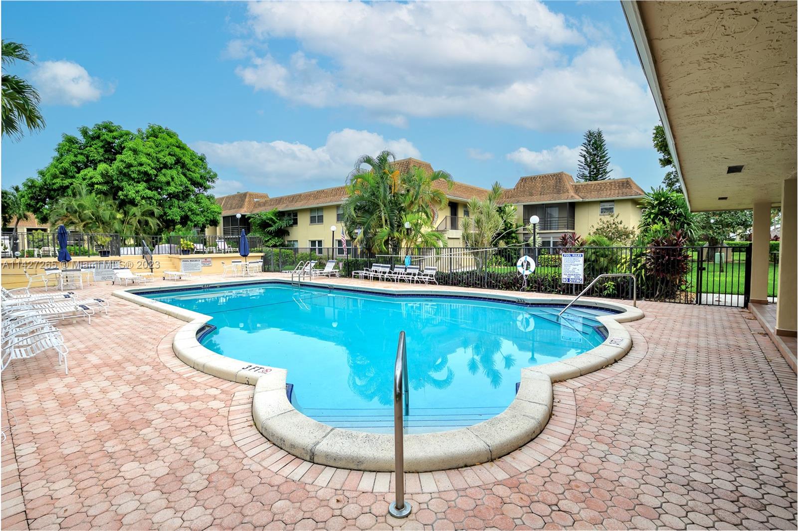 1231 Northwest 13th Street, Unit 472F Boca Raton, FL 33486 - Photo 20 of 22 a view of a swimming pool with a patio