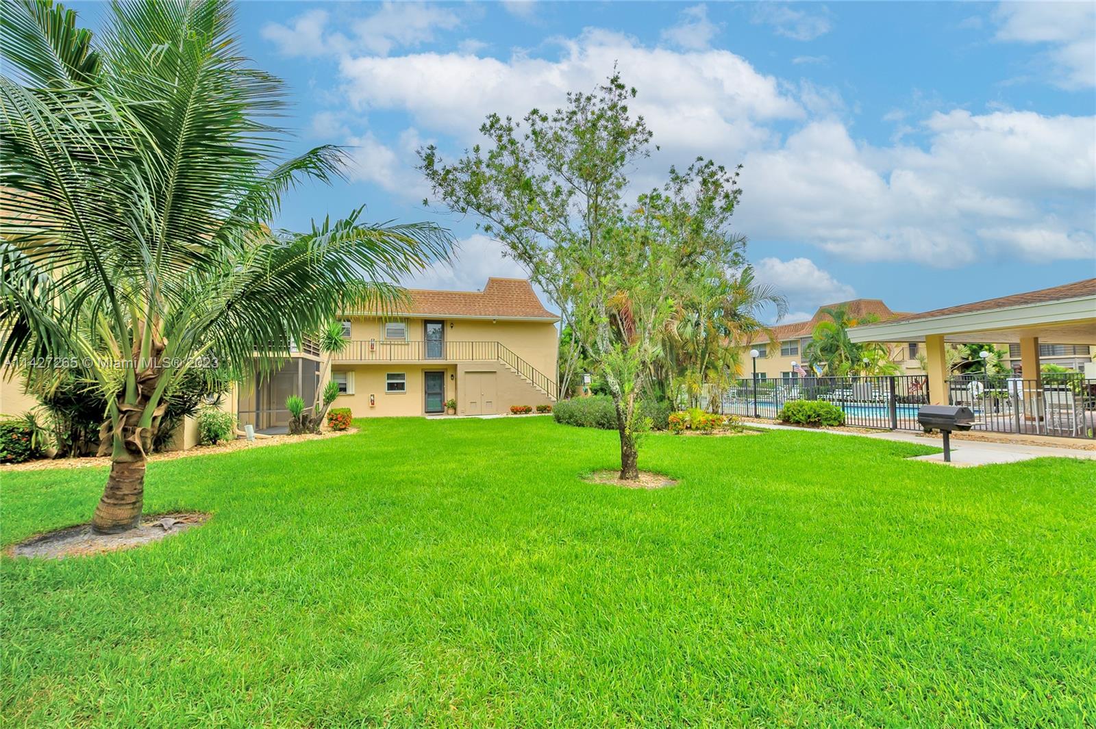 1231 Northwest 13th Street, Unit 472F Boca Raton, FL 33486 - Photo 22 of 22 a view of house with a garden