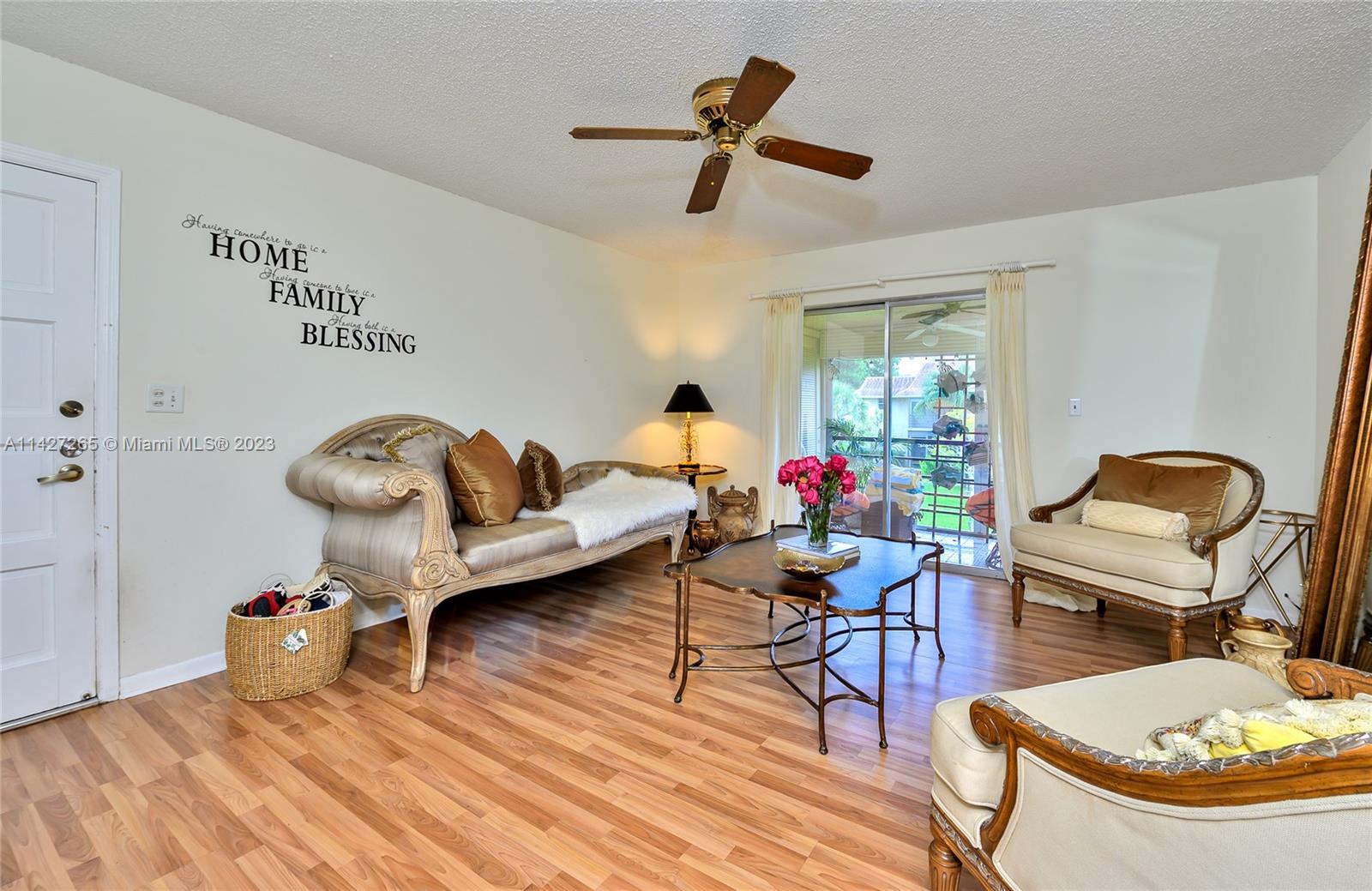 1231 Northwest 13th Street, Unit 472F Boca Raton, FL 33486 - Photo 7 of 22 a living room with furniture and a wooden floor