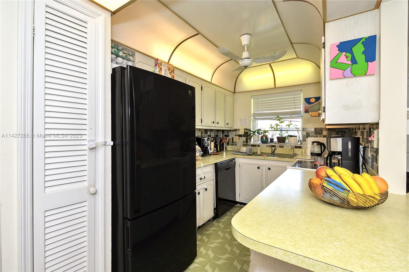 1231 Northwest 13th Street, Unit 472F Boca Raton, FL 33486 - Photo 9 of 22 a kitchen with stainless steel appliances granite countertop a sink a refrigerator and a stove