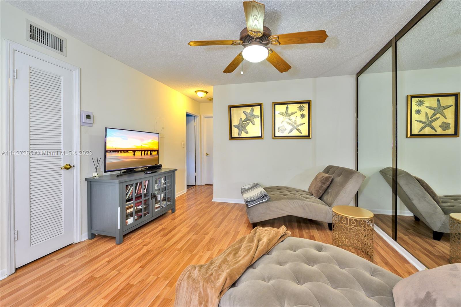 1231 Northwest 13th Street, Unit 472F Boca Raton, FL 33486 - Photo 10 of 22 a bedroom with furniture and a flat screen tv