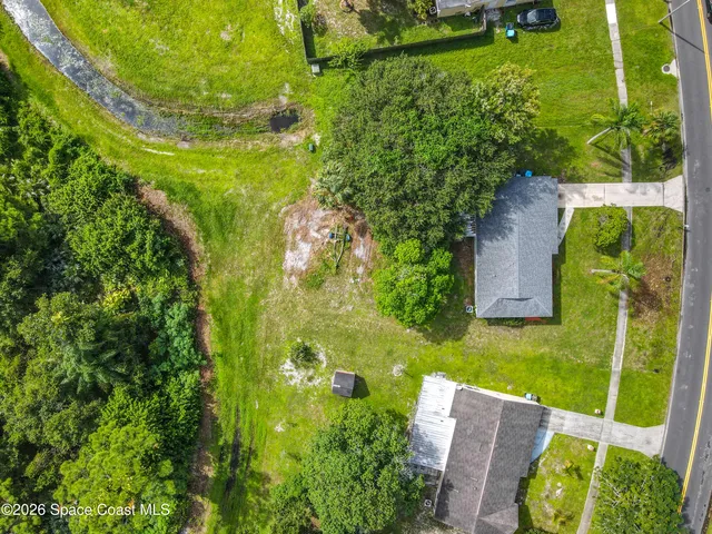 an aerial view of a house with a yard