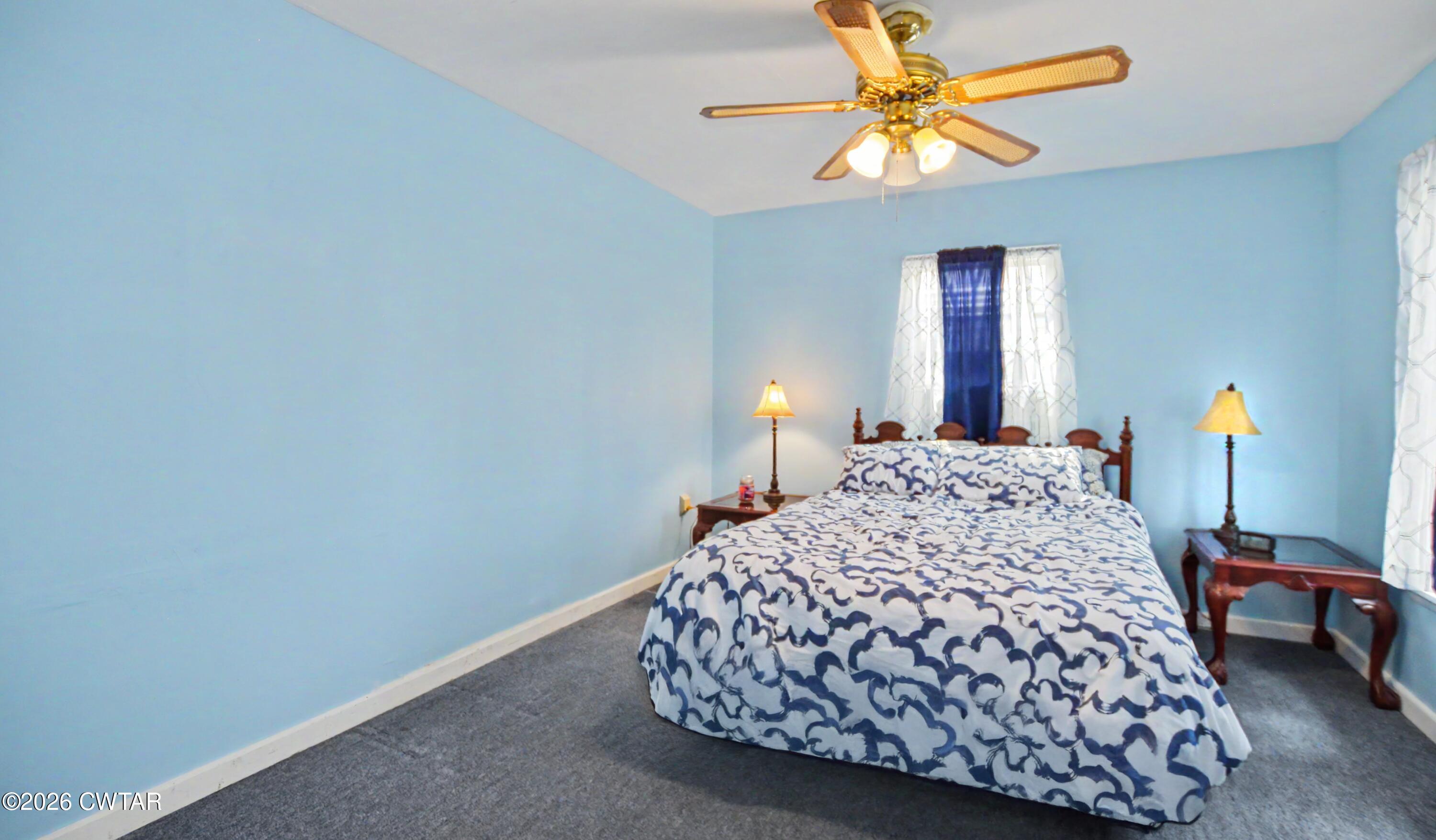 158 Depot Street Friendship, TN 38034 - Photo 14 of 16 a bedroom with a bed and a chandelier