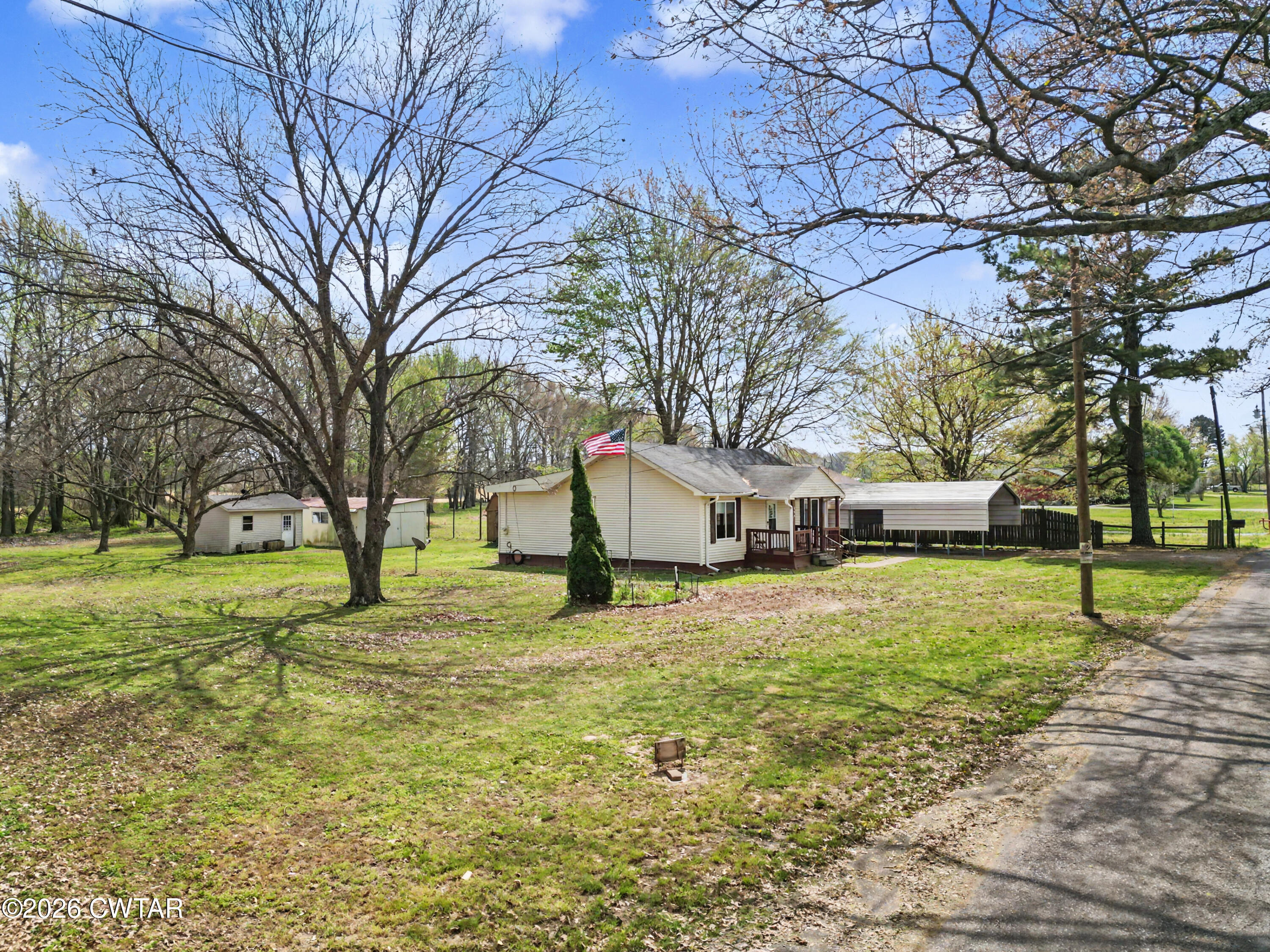 158 Depot Street Friendship, TN 38034 - Photo 2 of 16 a house with trees in front of it