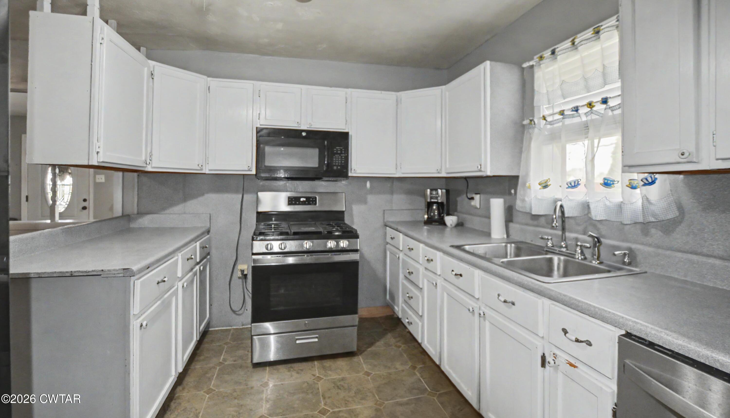 158 Depot Street Friendship, TN 38034 - Photo 9 of 16 a kitchen with stainless steel appliances granite countertop a sink stove a microwave and cabinets