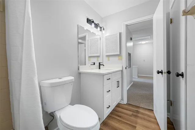 a bathroom with a double vanity sink toilet and shower