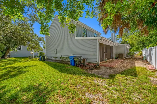 a view of backyard of house with green space