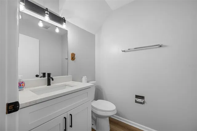 a bathroom with a sink a toilet and mirror