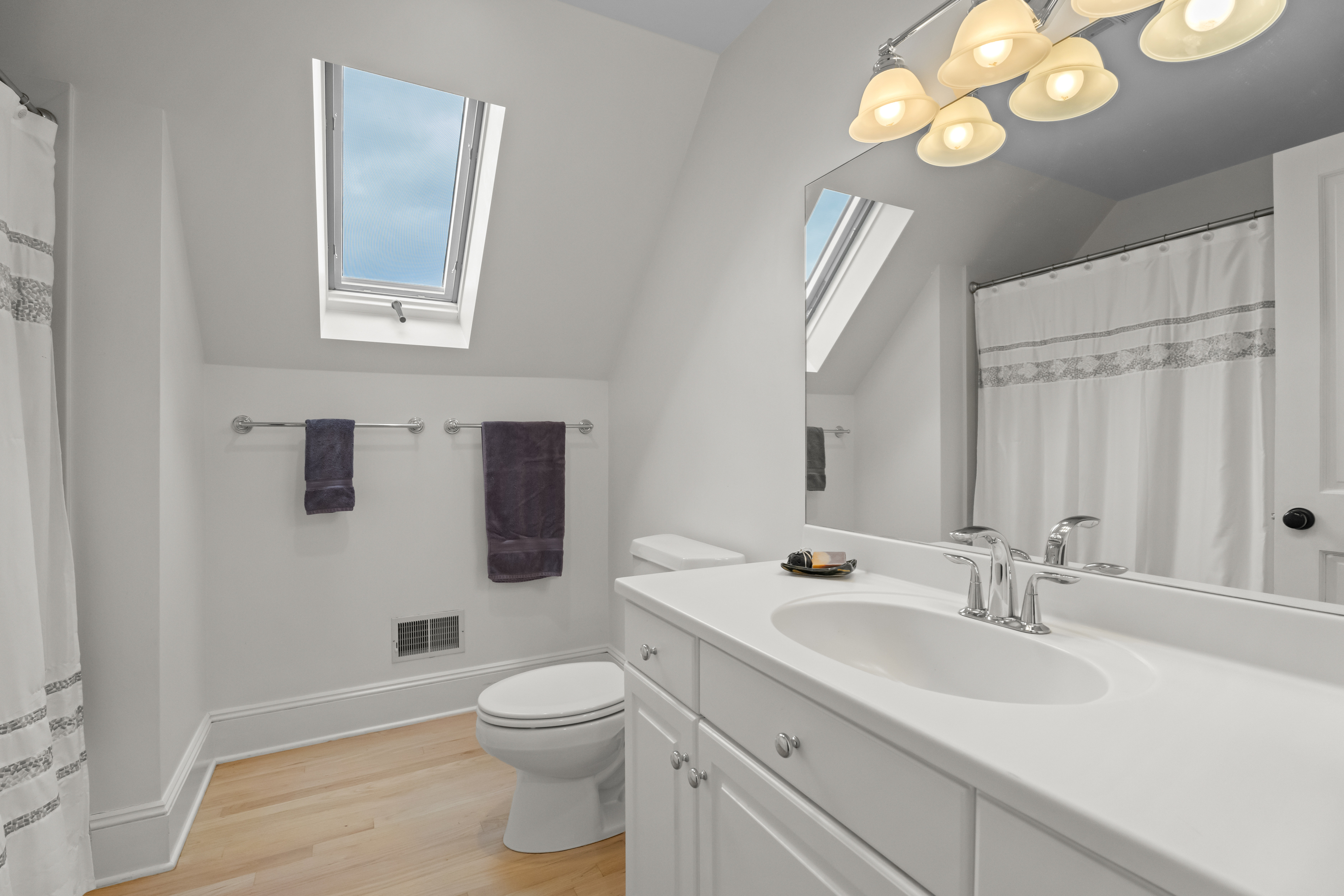 4 East Neck Road Stonington, CT 06378 - Photo 25 of 40 a bathroom with a toilet a sink and mirror