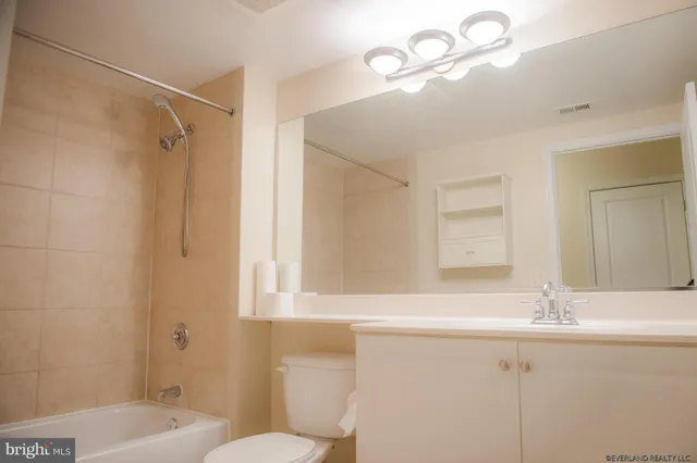 a kitchen with stainless steel appliances granite countertop a refrigerator a stove and a sink with wooden floor