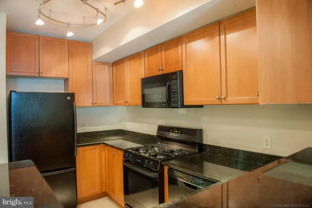 a kitchen with stainless steel appliances granite countertop a stove and a sink