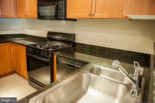a kitchen with a sink a stove and cabinets