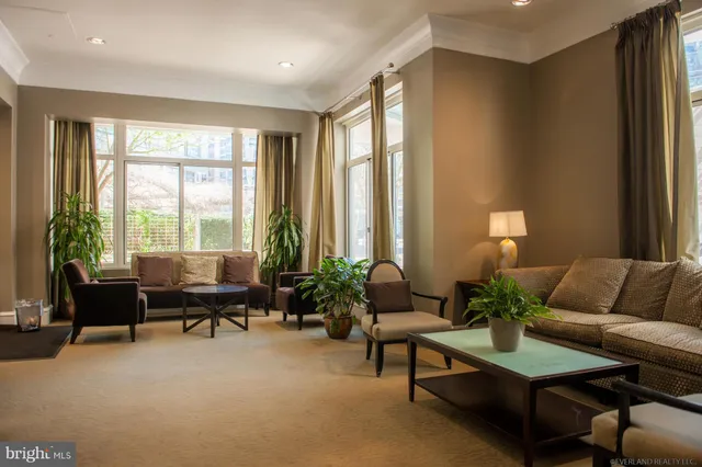 a view of a hallway with couch and mirror