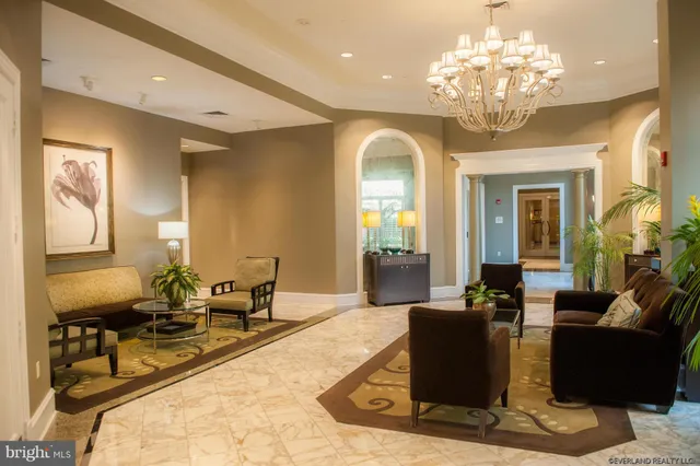 a living room with fireplace furniture and a chandelier