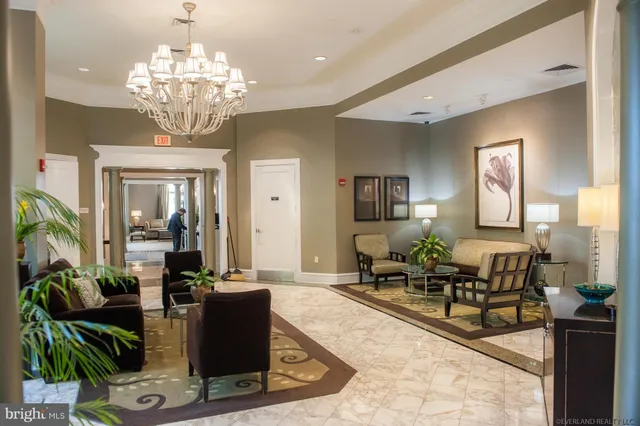 a view of a hallway with a glass door and a bathroom