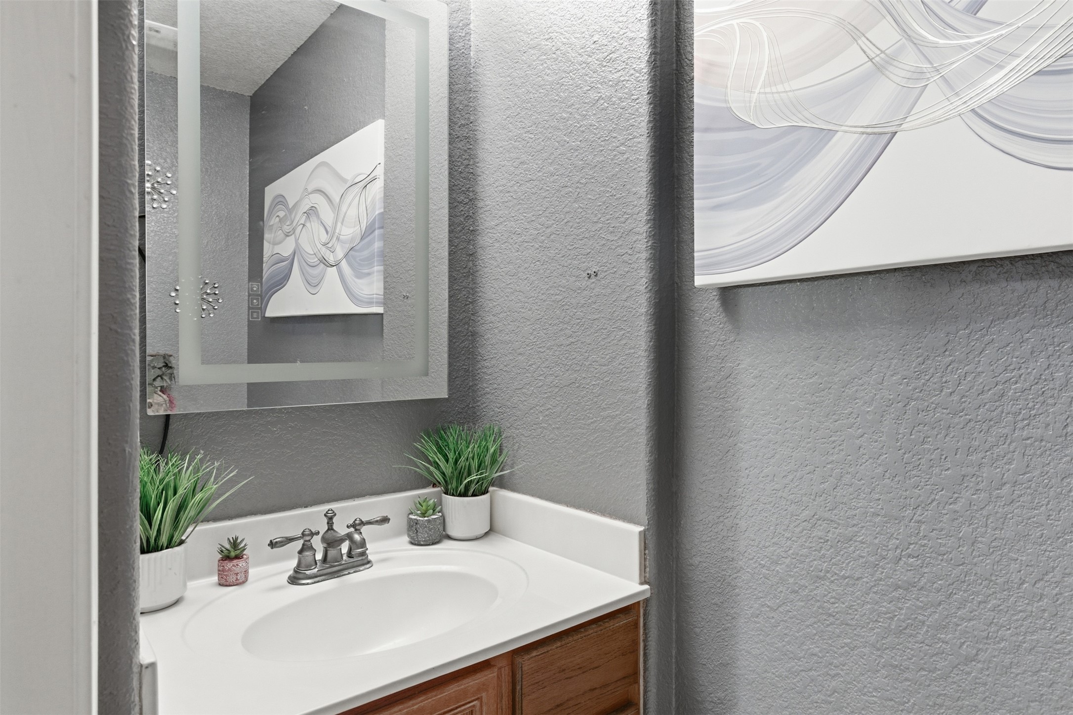 5701 Malarkey Road Del Valle, TX 78617 - Photo 12 of 27 Bathroom with a textured wall and vanity