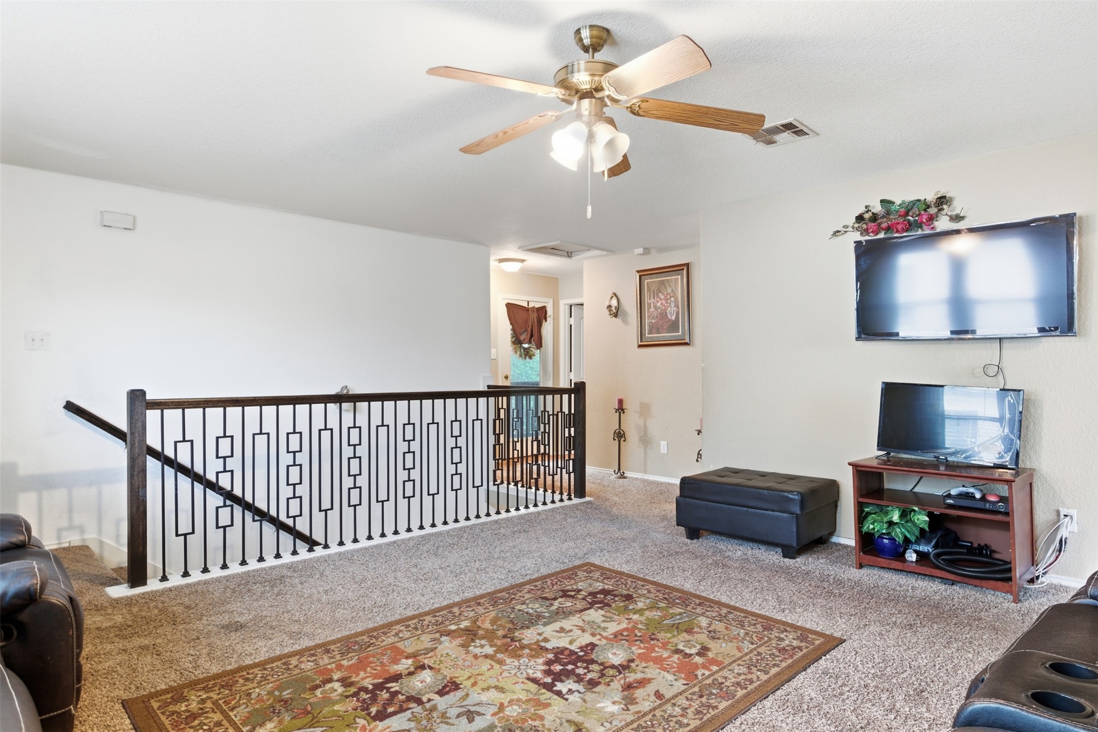 5701 Malarkey Road Del Valle, TX 78617 - Photo 13 of 27 Living room featuring carpet and ceiling fan