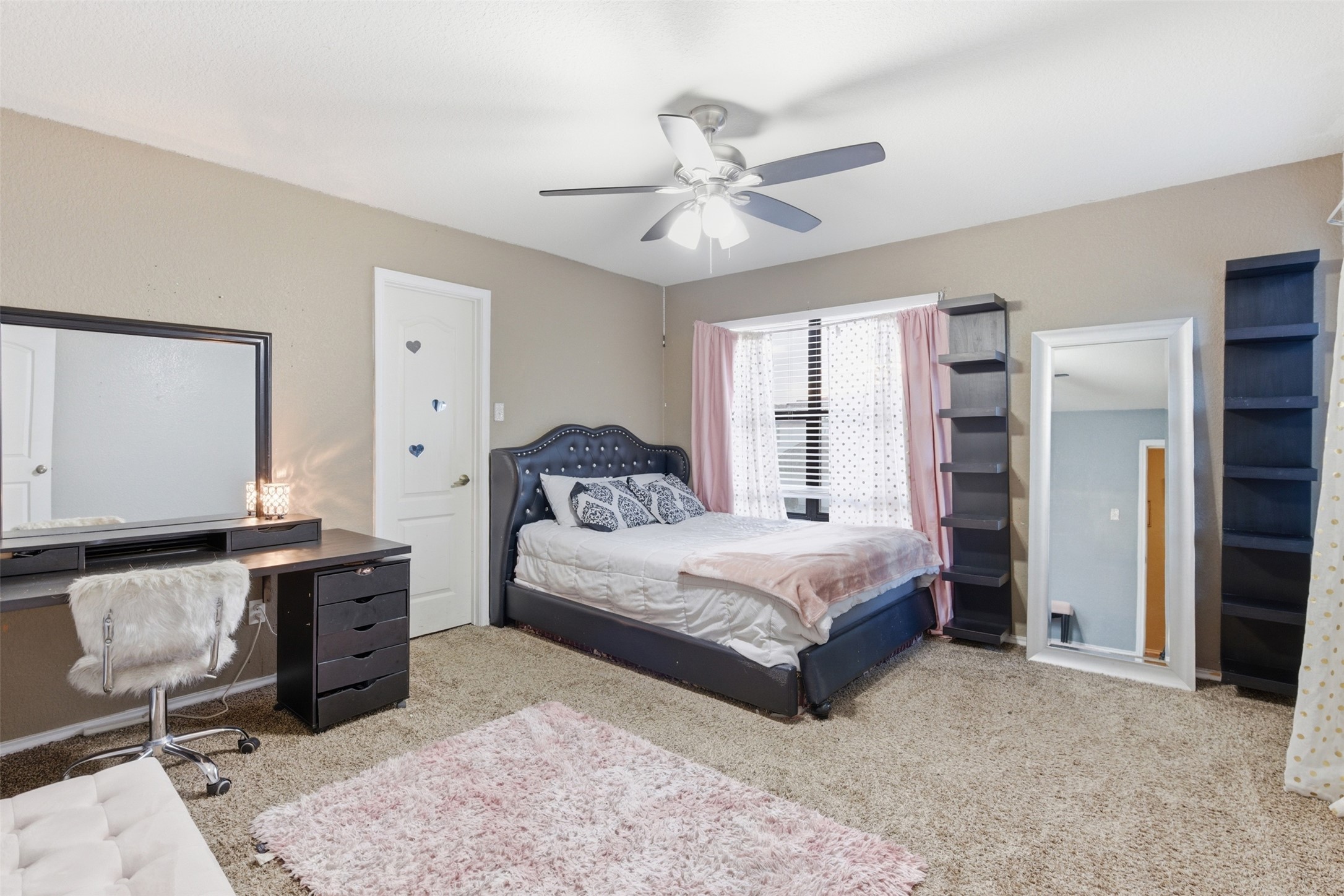 5701 Malarkey Road Del Valle, TX 78617 - Photo 16 of 27 Bedroom featuring light carpet and ceiling fan
