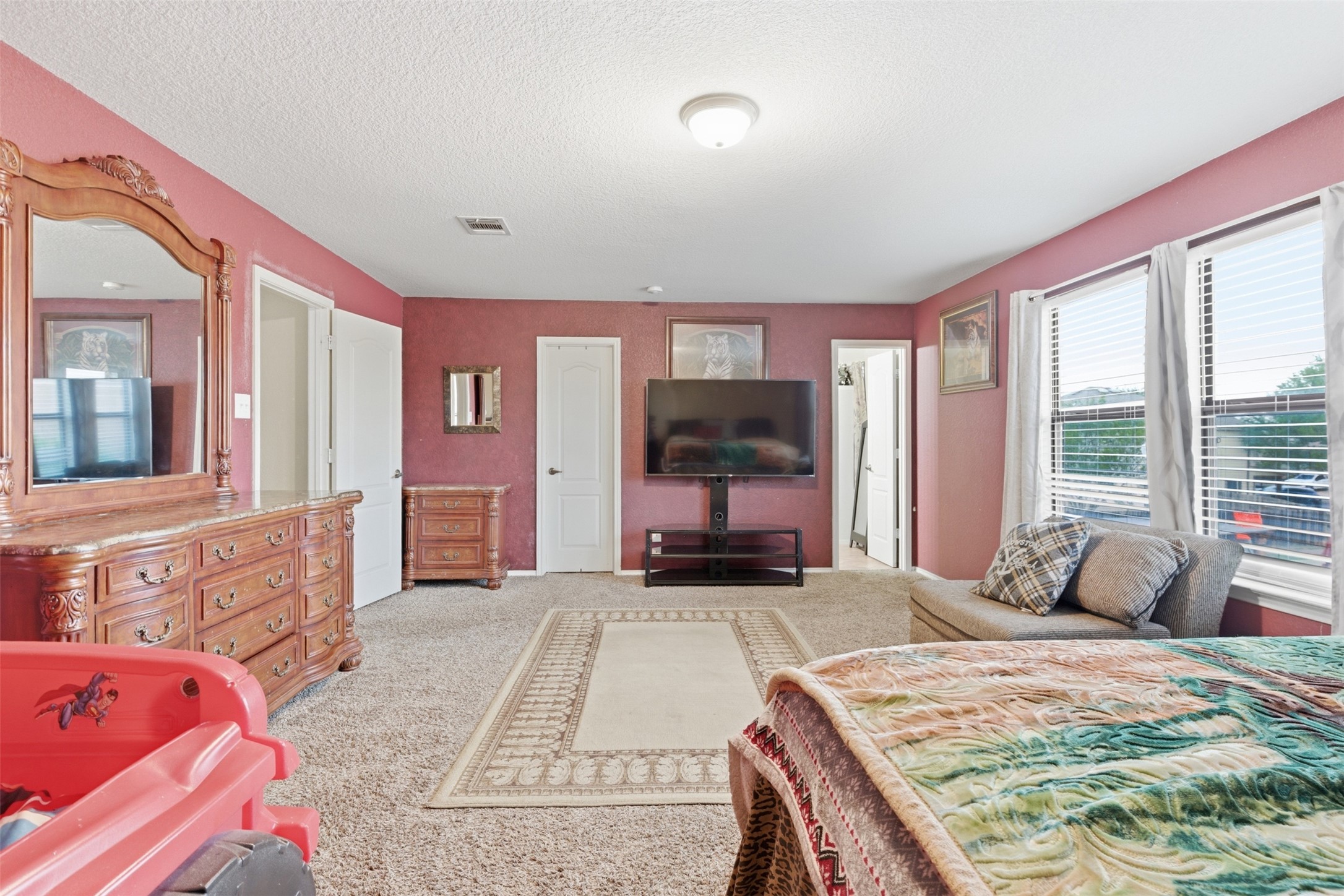 5701 Malarkey Road Del Valle, TX 78617 - Photo 19 of 27 Bedroom with light colored carpet and a textured ceiling