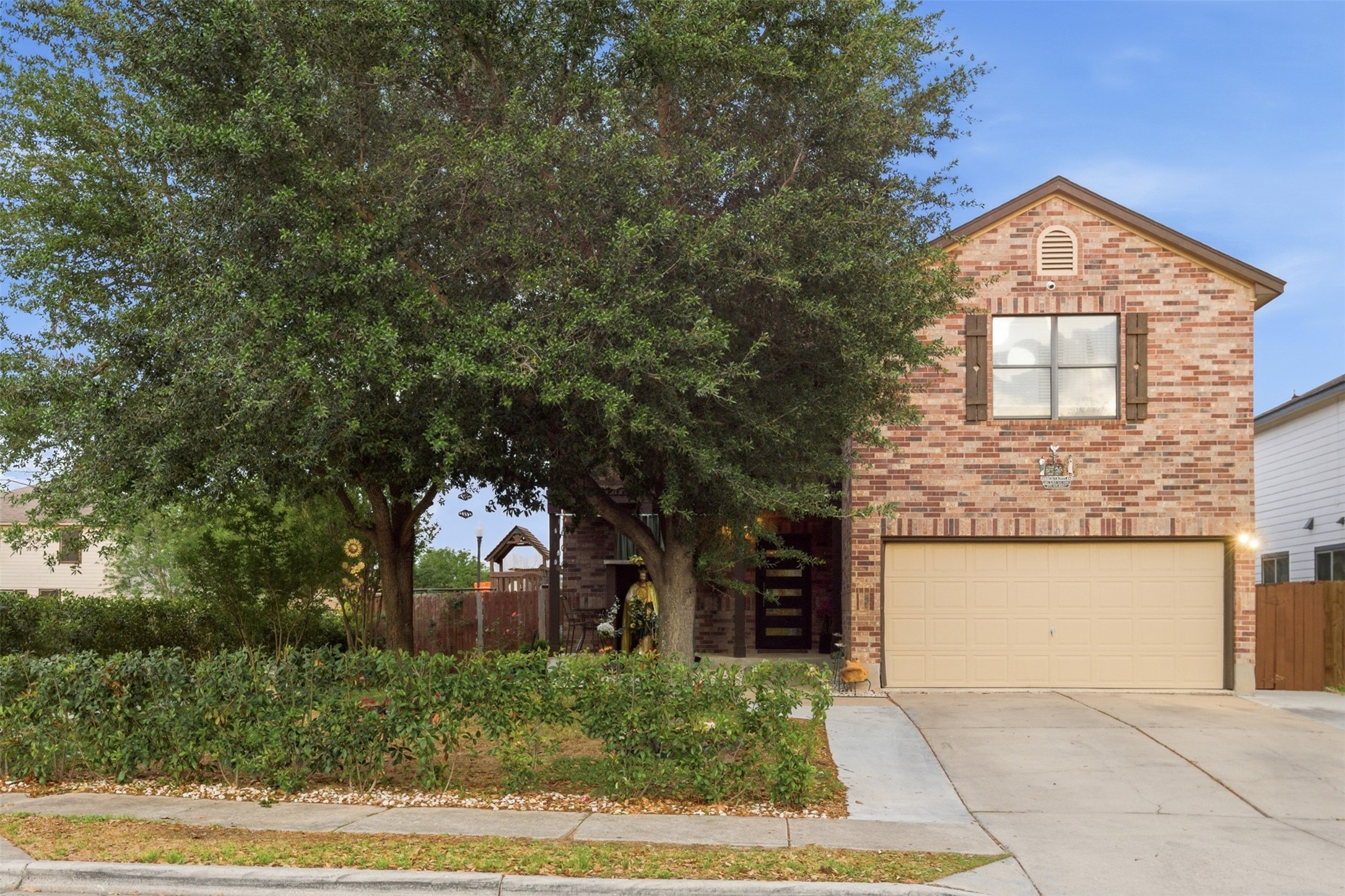 5701 Malarkey Road Del Valle, TX 78617 - Photo 2 of 27 View of front of house with concrete driveway, a garage, and brick siding