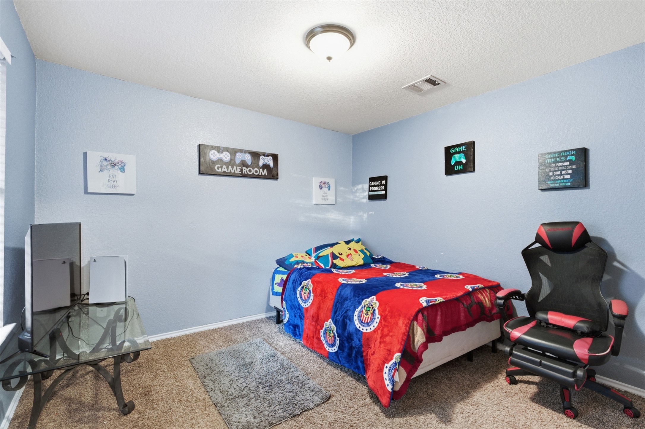 5701 Malarkey Road Del Valle, TX 78617 - Photo 21 of 27 Bedroom featuring light colored carpet and a textured ceiling