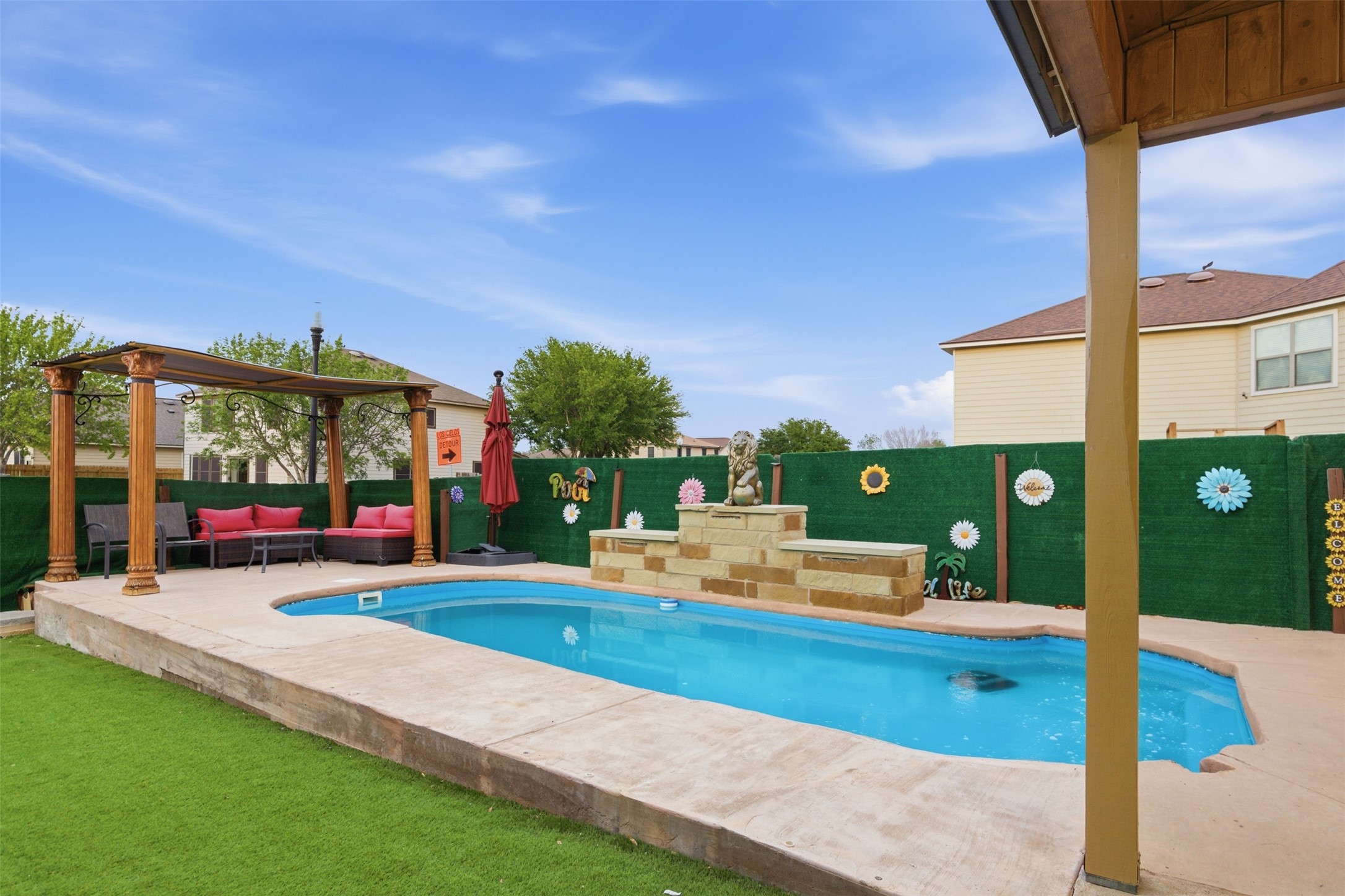 5701 Malarkey Road Del Valle, TX 78617 - Photo 24 of 27 View of swimming pool with an outdoor hangout area, patio surround, and a fenced backyard