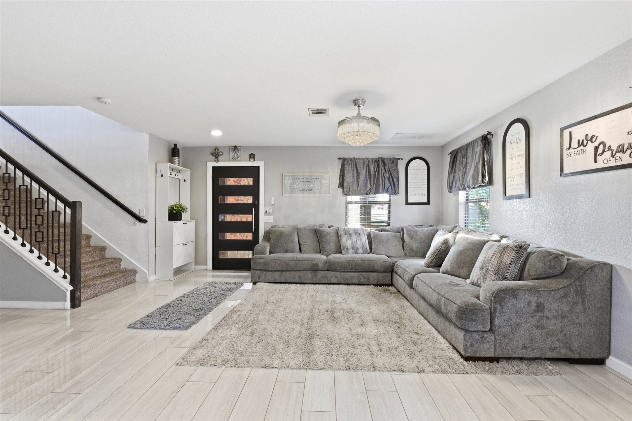 5701 Malarkey Road Del Valle, TX 78617 - Photo 4 of 27 Living room featuring stairway and wood finish floors
