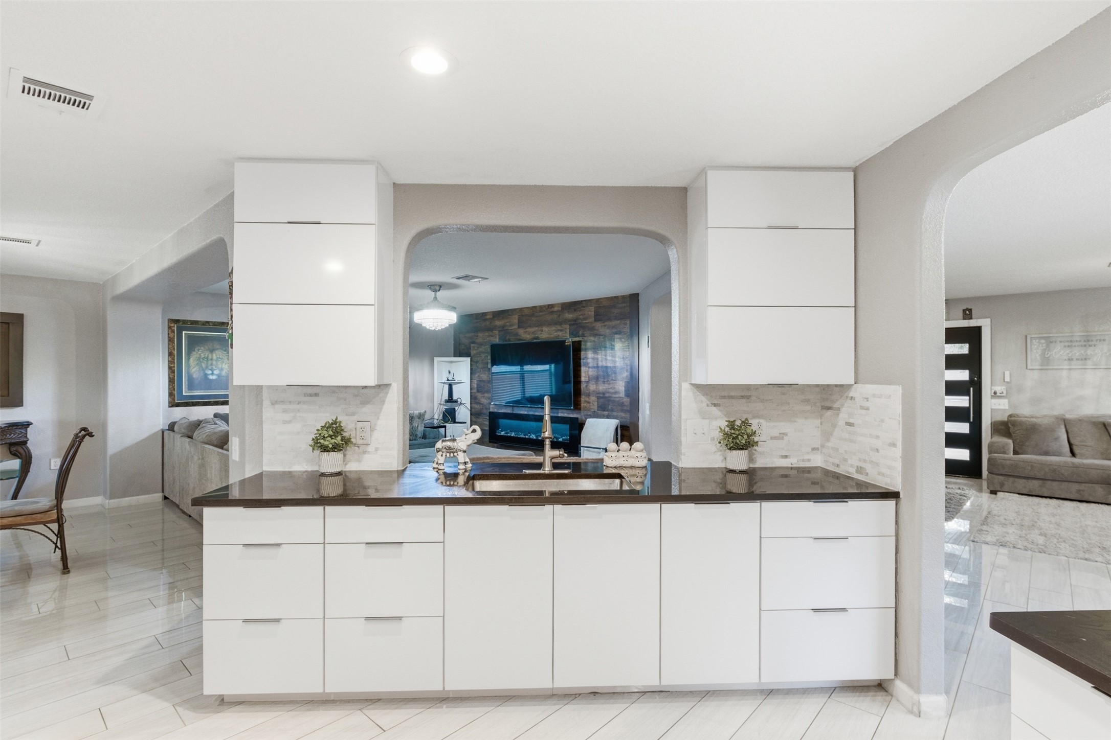 5701 Malarkey Road Del Valle, TX 78617 - Photo 27 of 27 Kitchen featuring open floor plan, modern cabinets, and decorative backsplash